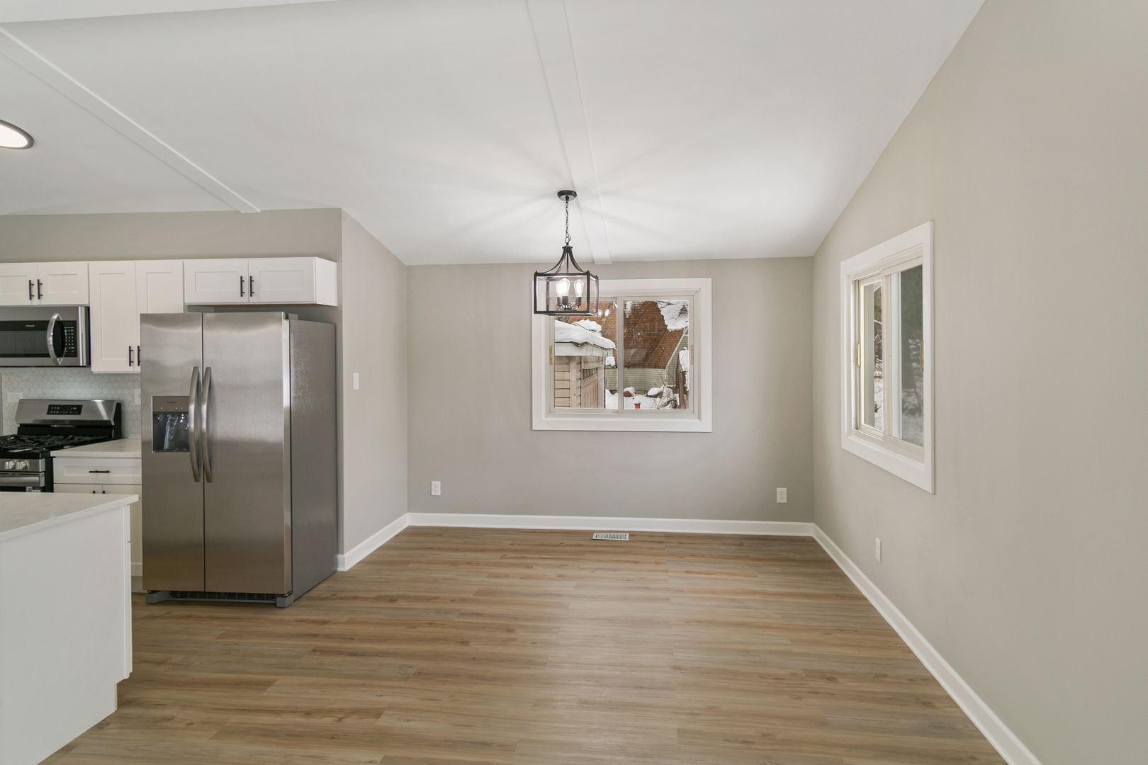 6305 Robert Road Cary, IL 60013 - Photo 8 of 23 a view of a kitchen with wooden floor electronic appliances and window