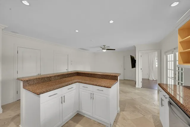 a large kitchen with stainless steel appliances lots of counter space and a sink