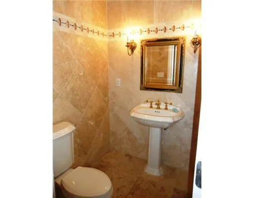 a bathroom with a toilet and a mirror