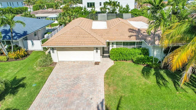 a aerial view of a house with a yard and potted plants