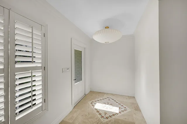 a view of wooden floor and windows in a room