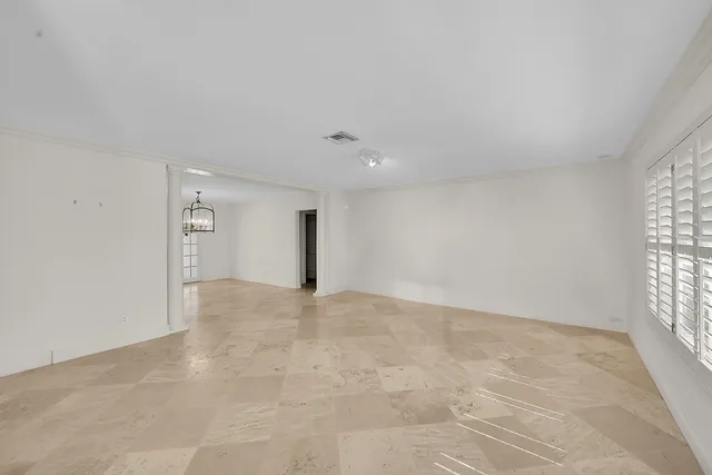 an empty room with windows and entrance