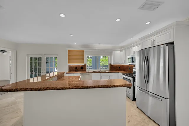 a kitchen with granite countertop a sink and a window