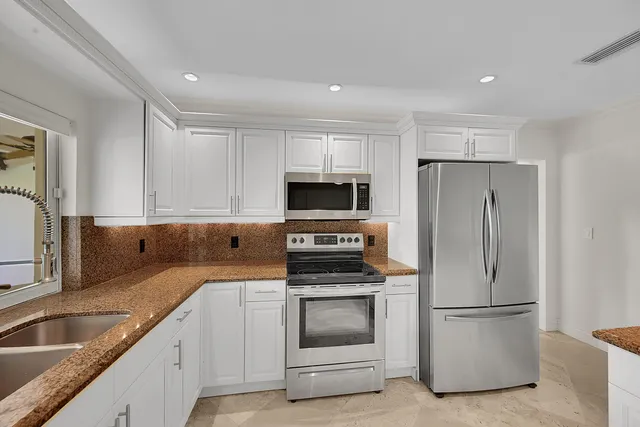 a kitchen with a sink and refrigerator