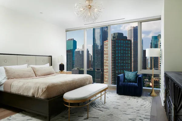 a bedroom with a balcony a bed and a couch