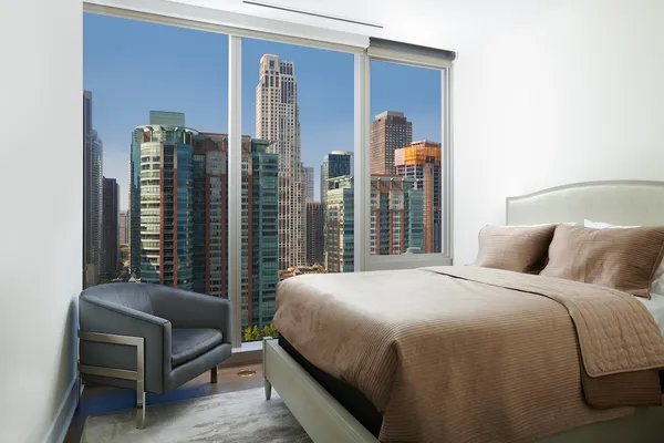 a bedroom with a bed and a couch