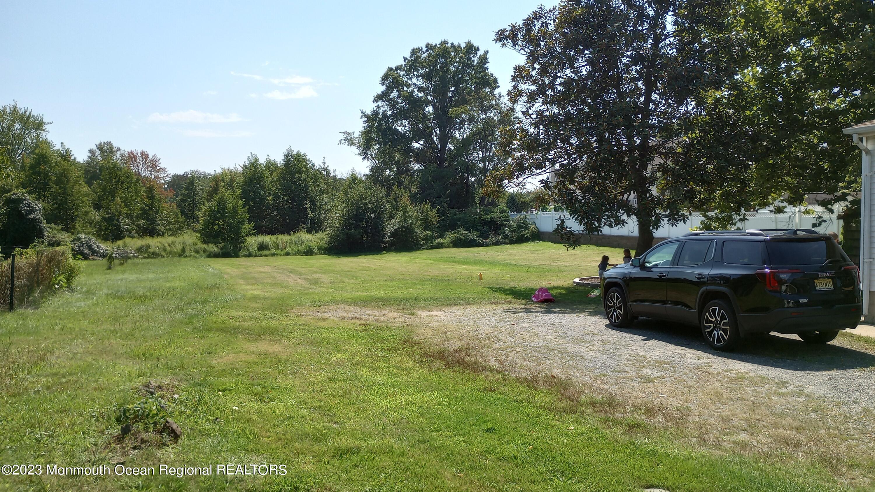 258 Gordon Road Old Bridge, NJ 07747 - Photo 3 of 12 a backyard of a house with barbeque oven and yard in the back
