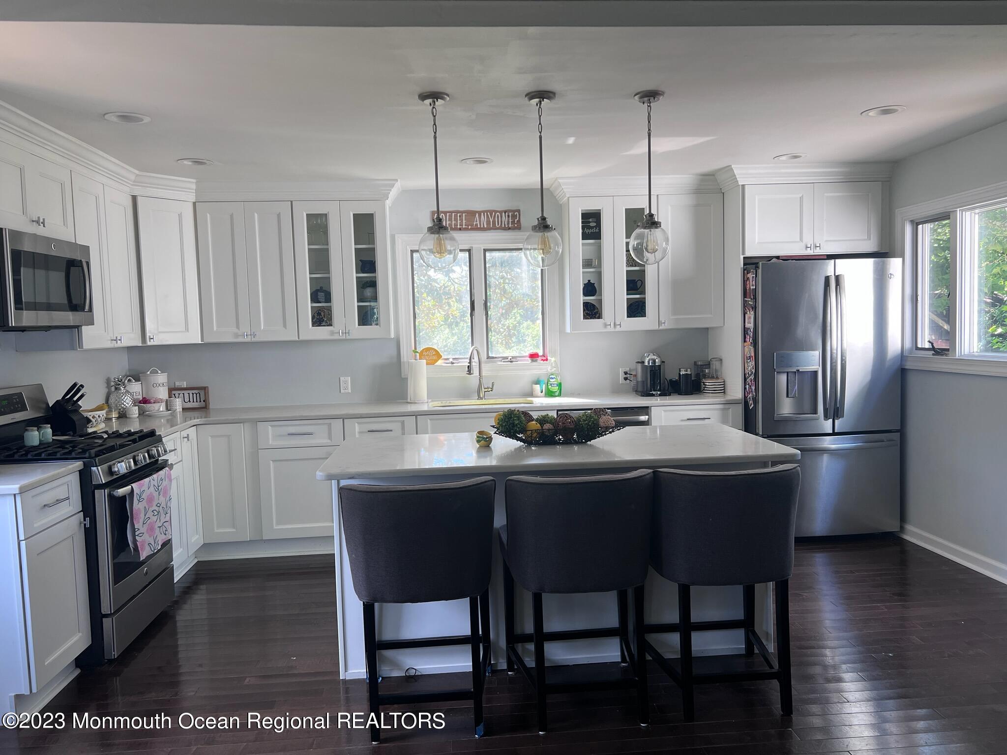 258 Gordon Road Old Bridge, NJ 07747 - Photo 7 of 12 a kitchen with stainless steel appliances granite countertop a stove a refrigerator a sink dishwasher a dining table and chairs with wooden floor