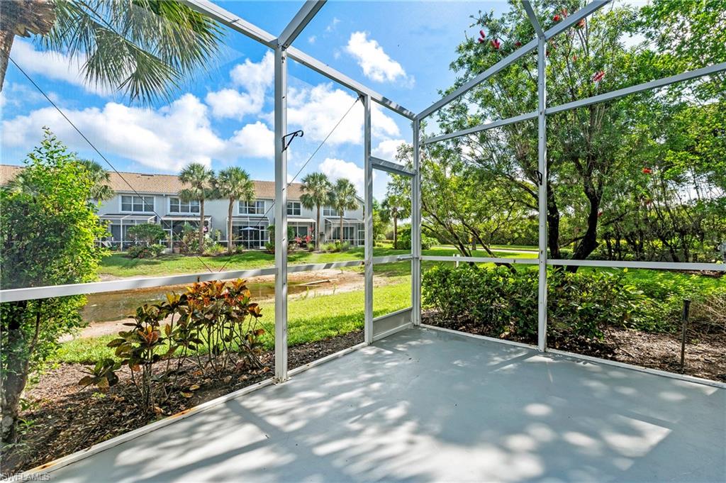 15570 Marcello Circle, Unit 149 Naples, FL 34110 - Photo 13 of 31 a view of a garden with wooden fence