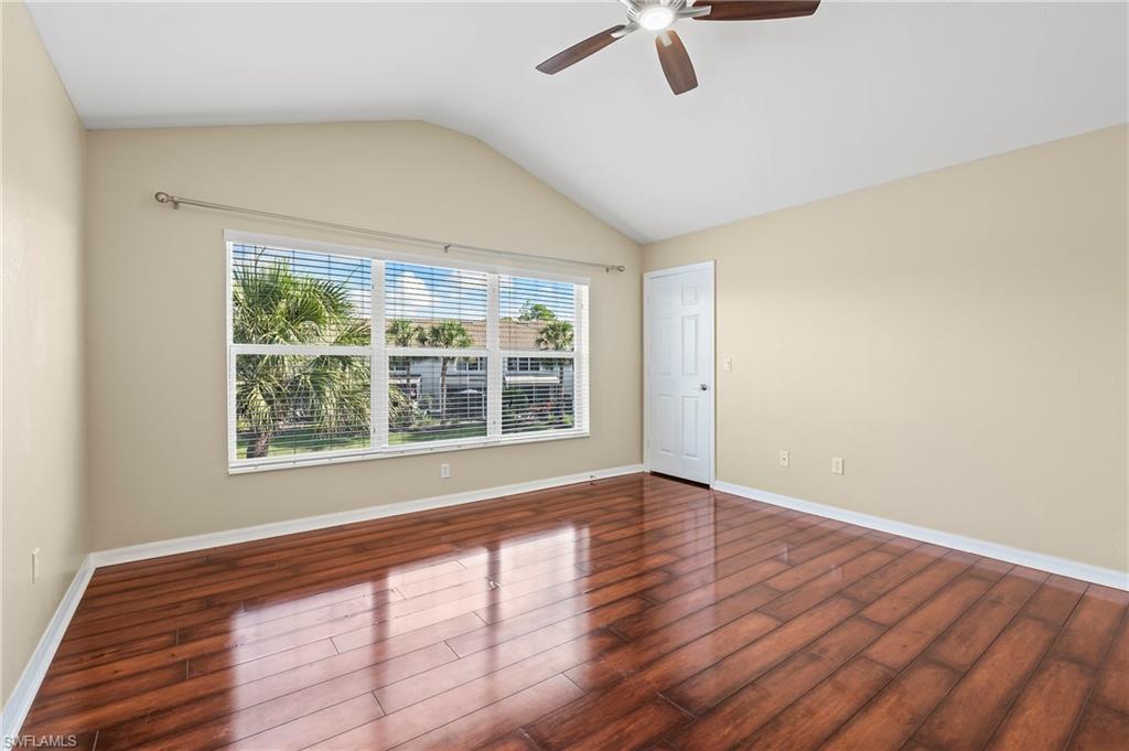 15570 Marcello Circle, Unit 149 Naples, FL 34110 - Photo 16 of 31 a view of an empty room with a window and wooden floor
