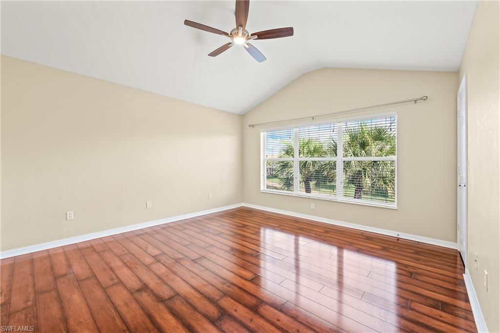 15570 Marcello Circle, Unit 149 Naples, FL 34110 - Photo 17 of 31 a view of an empty room with wooden floor and a window