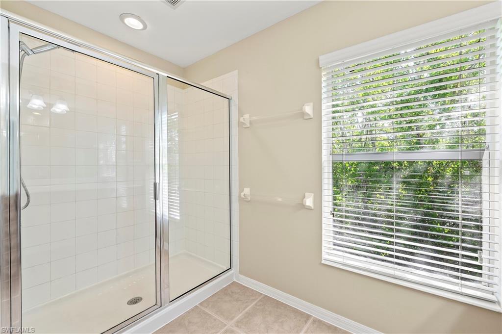 15570 Marcello Circle, Unit 149 Naples, FL 34110 - Photo 18 of 31 a bathroom with a shower and a window