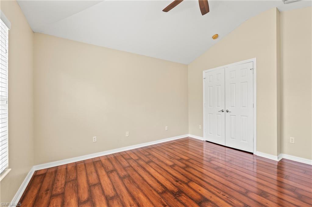 15570 Marcello Circle, Unit 149 Naples, FL 34110 - Photo 22 of 31 a view of an empty room with wooden floor