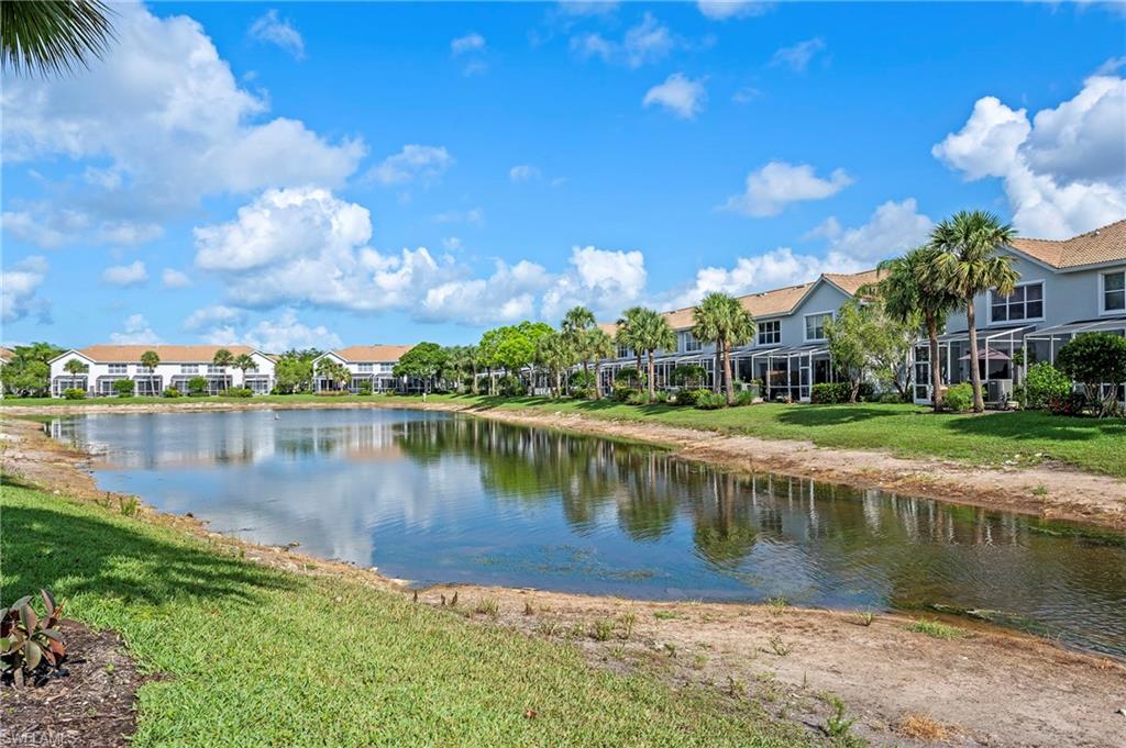 15570 Marcello Circle, Unit 149 Naples, FL 34110 - Photo 26 of 31 a view of a lake with houses in the background