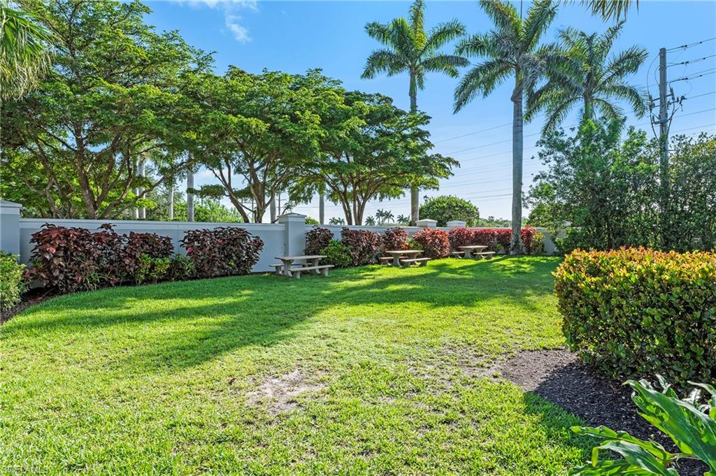 15570 Marcello Circle, Unit 149 Naples, FL 34110 - Photo 31 of 31 a front view of a house with garden