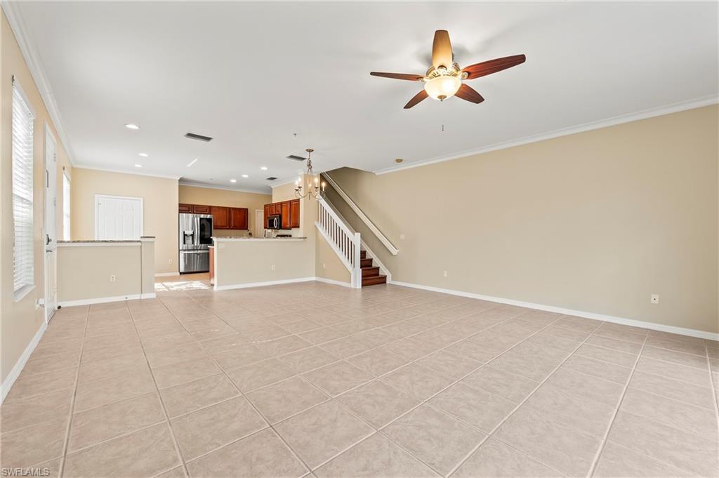 15570 Marcello Circle, Unit 149 Naples, FL 34110 - Photo 5 of 31 a view of an empty room with a ceiling fan