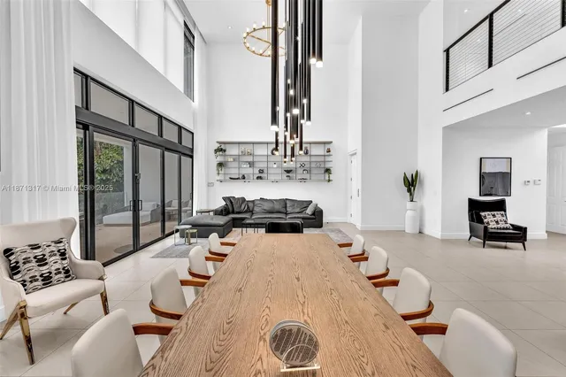 a living room with furniture and large windows