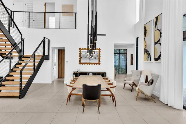 a living room with furniture and a painting on the wall