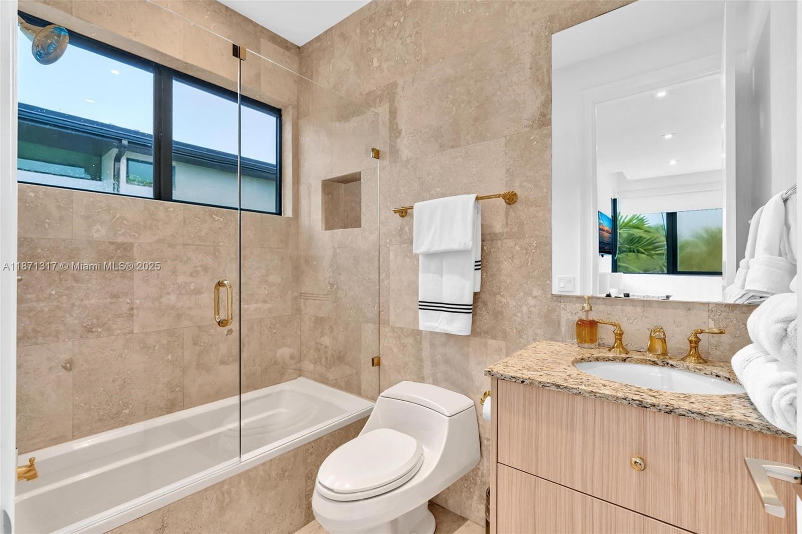 1350 98th Street Bay Harbor Islands, FL 33154 - Photo 22 of 46 a bathroom with a granite countertop sink toilet and shower