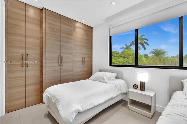 a bedroom with two beds and a wall painting