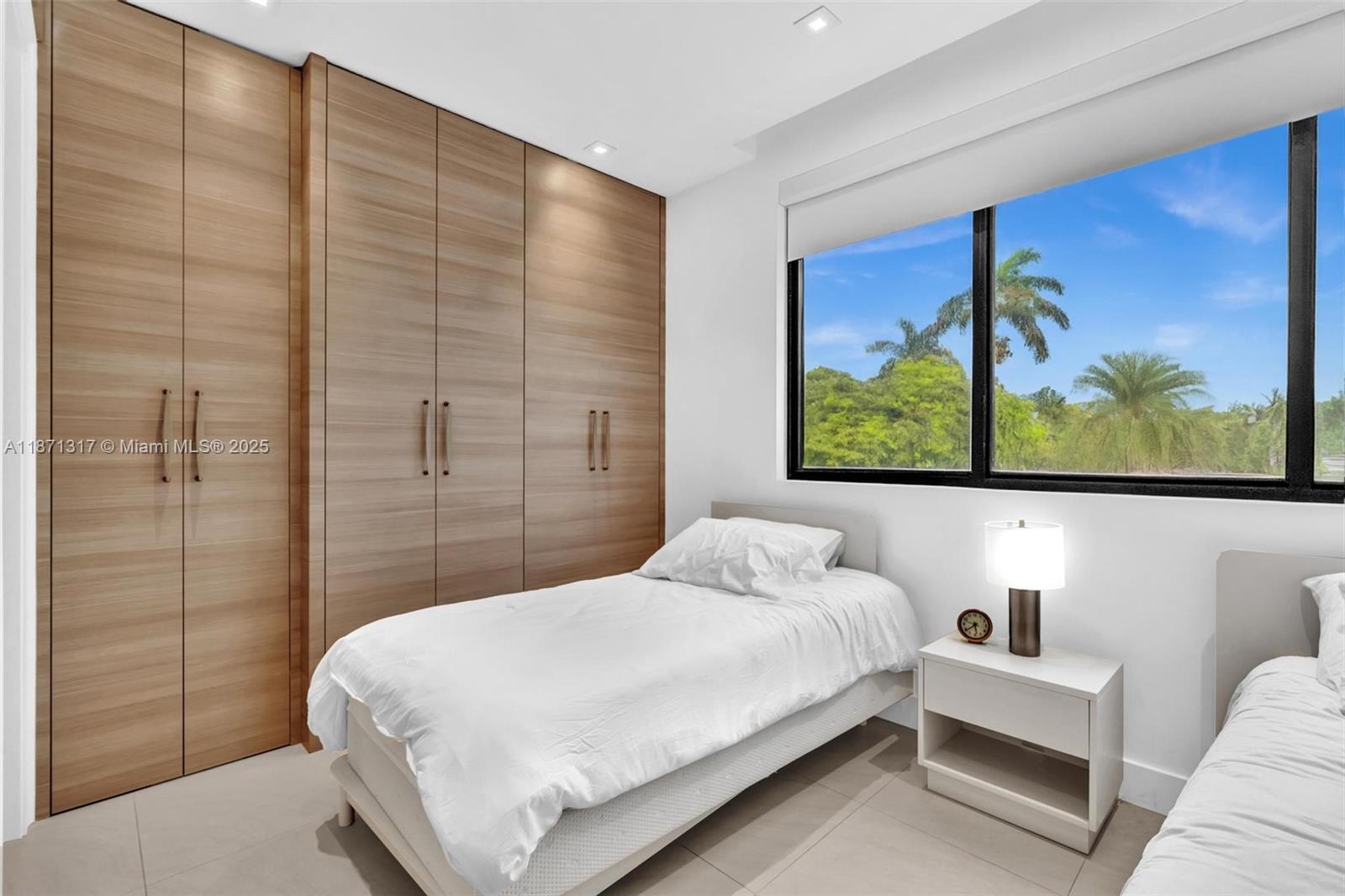 1350 98th Street Bay Harbor Islands, FL 33154 - Photo 27 of 46 a bedroom with a bed and a painting on the wall