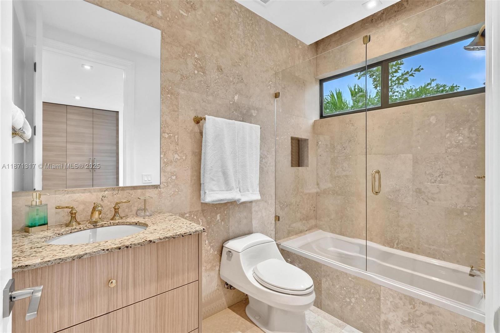 1350 98th Street Bay Harbor Islands, FL 33154 - Photo 29 of 46 a bathroom with a granite countertop sink toilet and shower