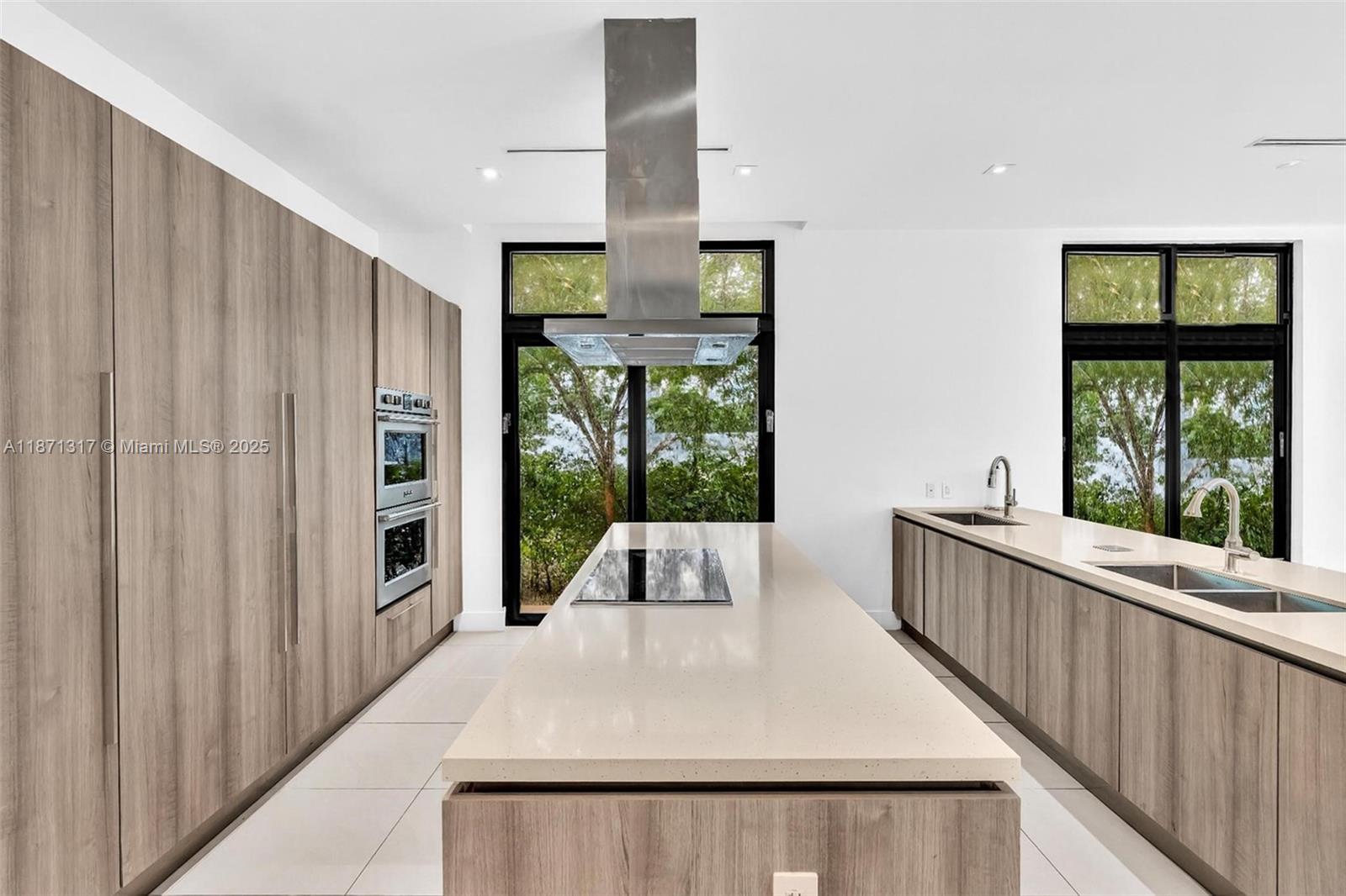 1350 98th Street Bay Harbor Islands, FL 33154 - Photo 3 of 46 a large white kitchen with a large window