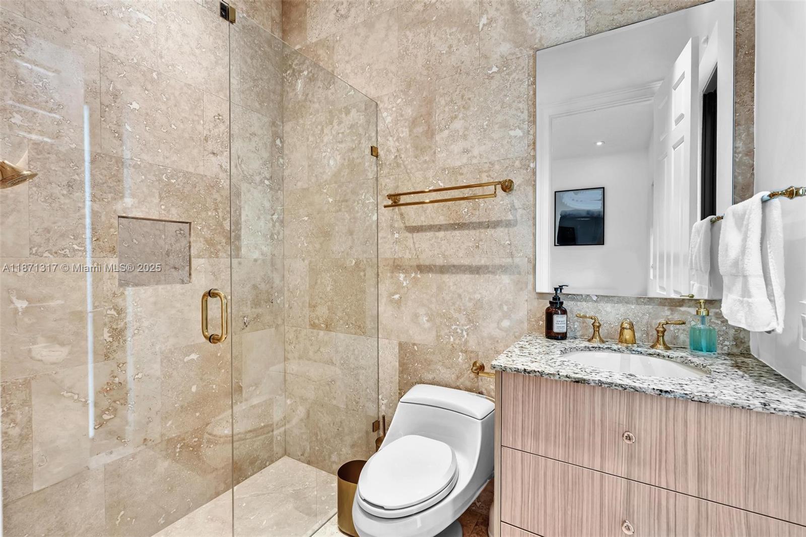 1350 98th Street Bay Harbor Islands, FL 33154 - Photo 33 of 46 a bathroom with a granite countertop sink toilet a mirror and shower