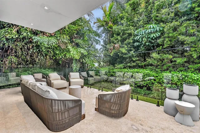 a front view of house with yard fountain and outdoor seating