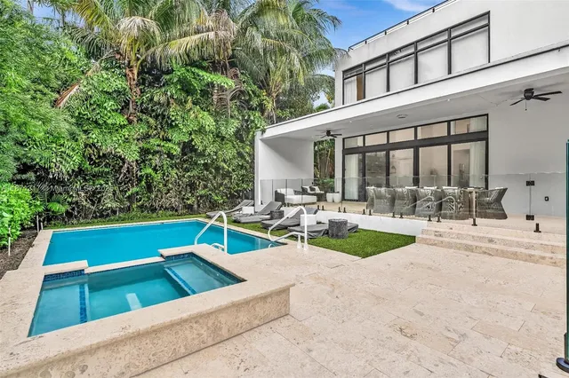 a view of a backyard with sitting area
