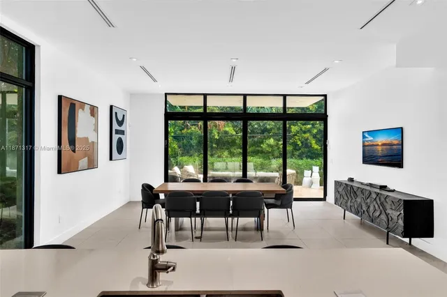 a living room with furniture a large window and a flat screen tv