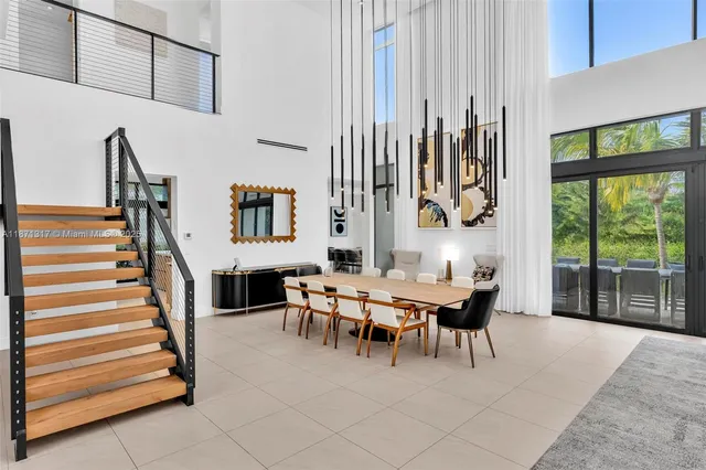 a dining room with furniture and a large window