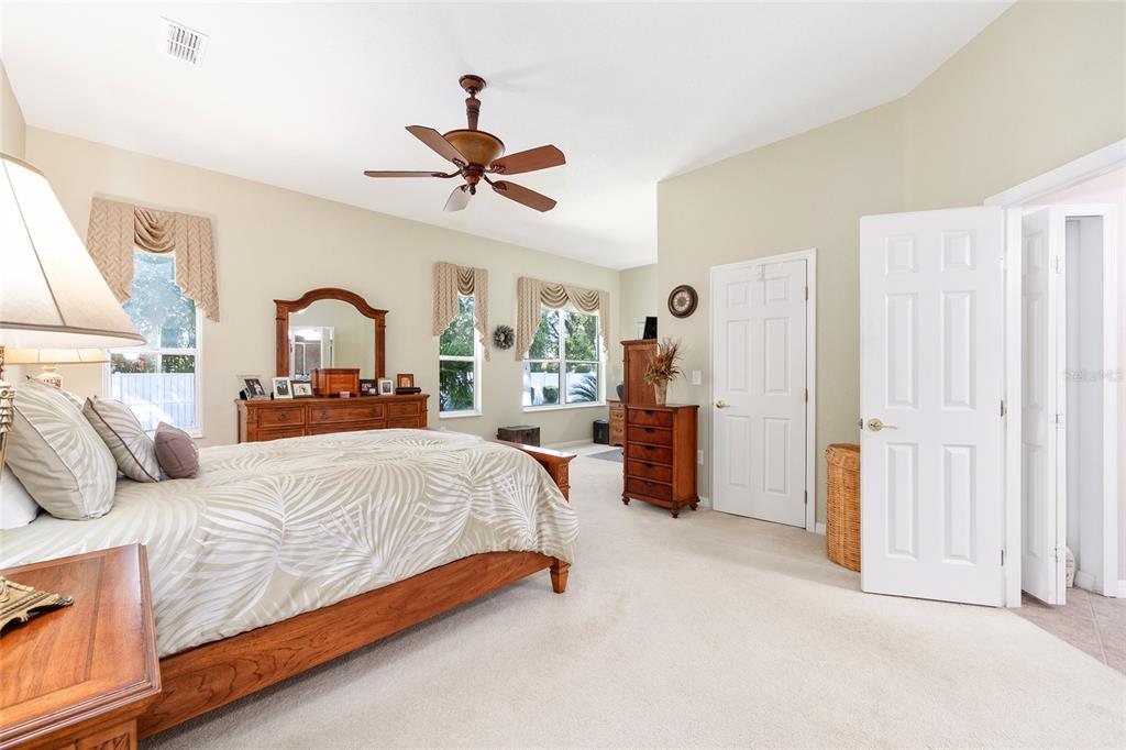 10751 Southwest 71st Circle Ocala, FL 34476 - Photo 14 of 52 a bedroom with a bed and a chandelier