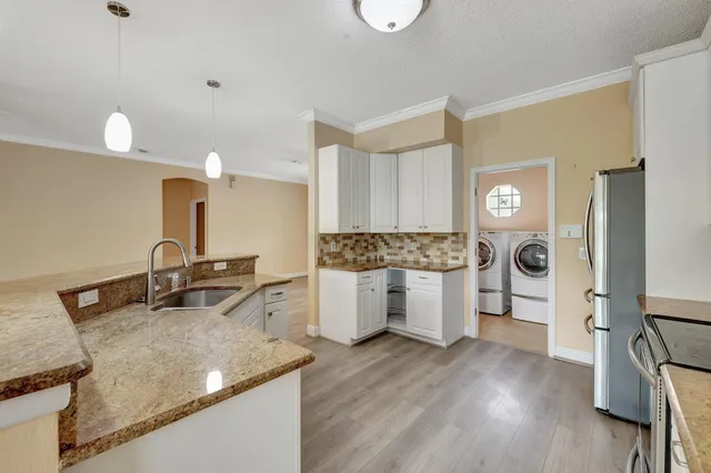 a kitchen with a stove a sink and a refrigerator