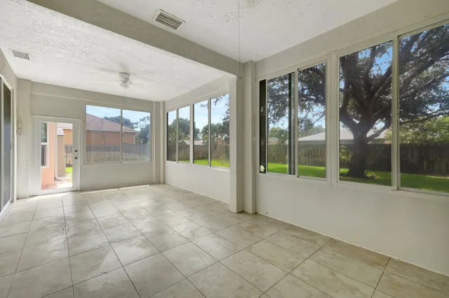 a view of an empty room with a sliding door and balcony