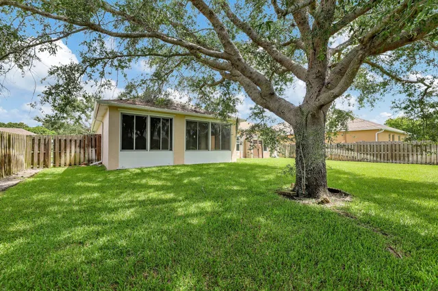 a view of a house with a backyard