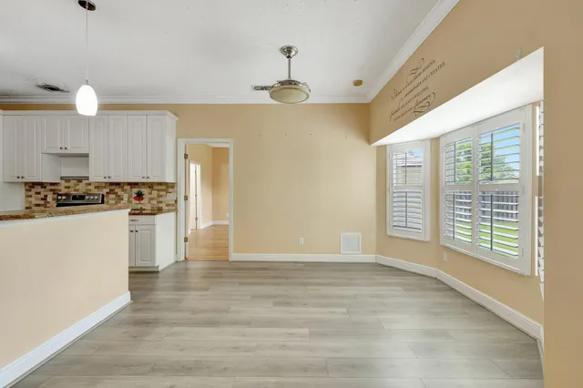 a view of kitchen with stove and cabinets