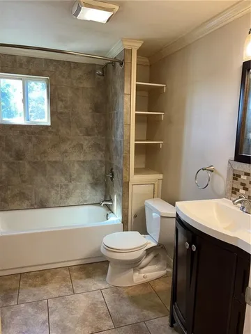 a bathroom with a sink a toilet a mirror and a bathtub