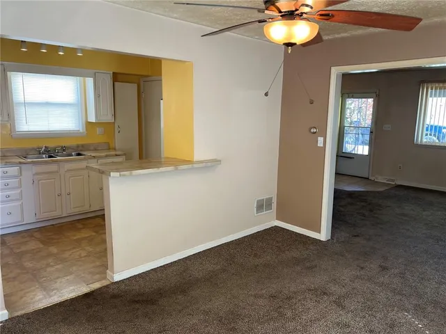 an empty room with a mirror and a sink