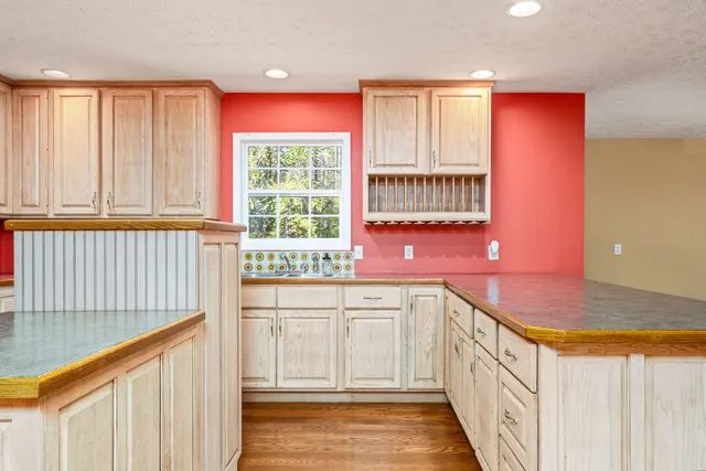 a kitchen with a sink stove and cabinets