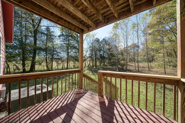 a view of roof deck with wooden floor and wooden fence