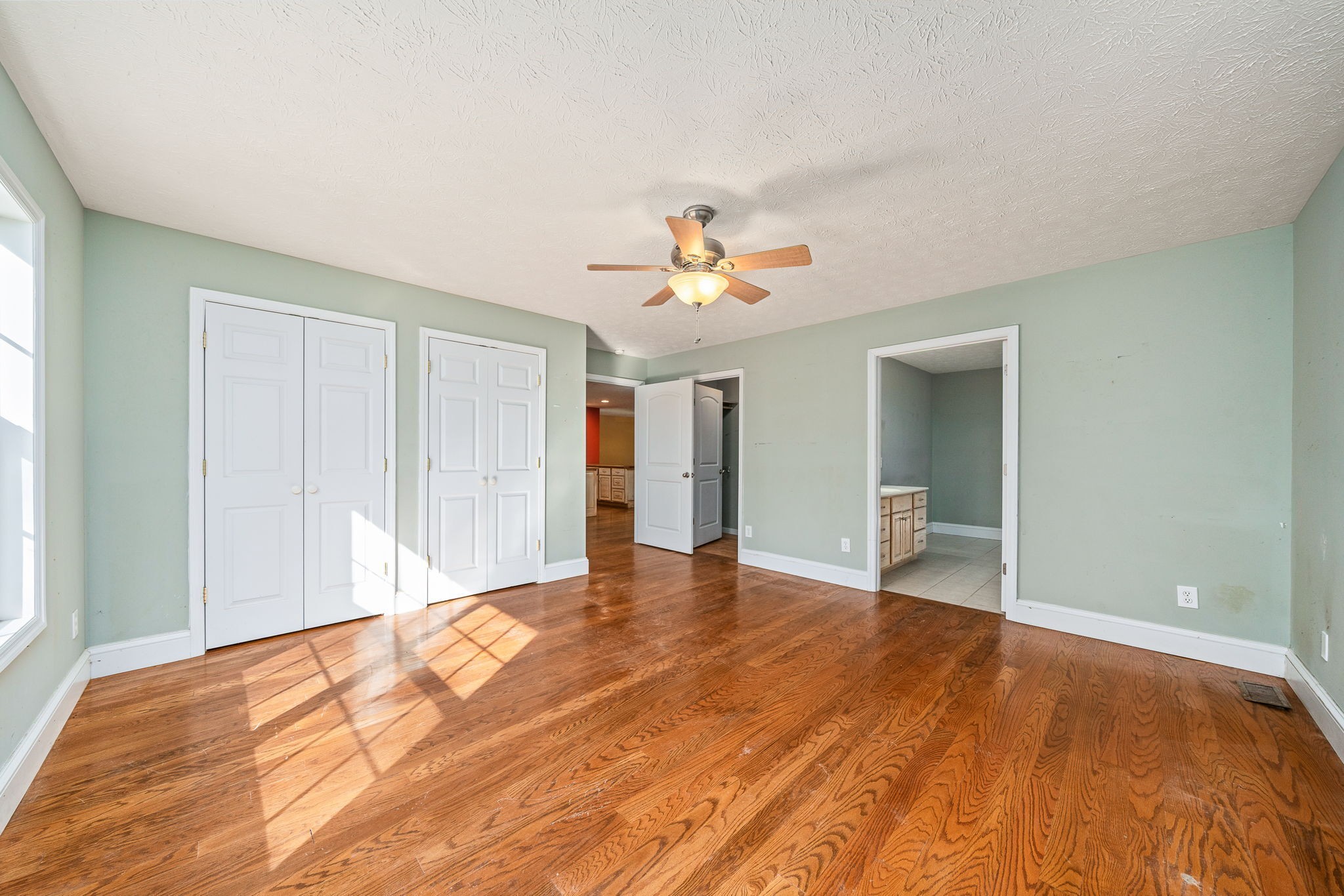 375 Golden Herren Road Sparta, TN 38583 - Photo 32 of 45 a view of an empty room with wooden floor and a ceiling fan