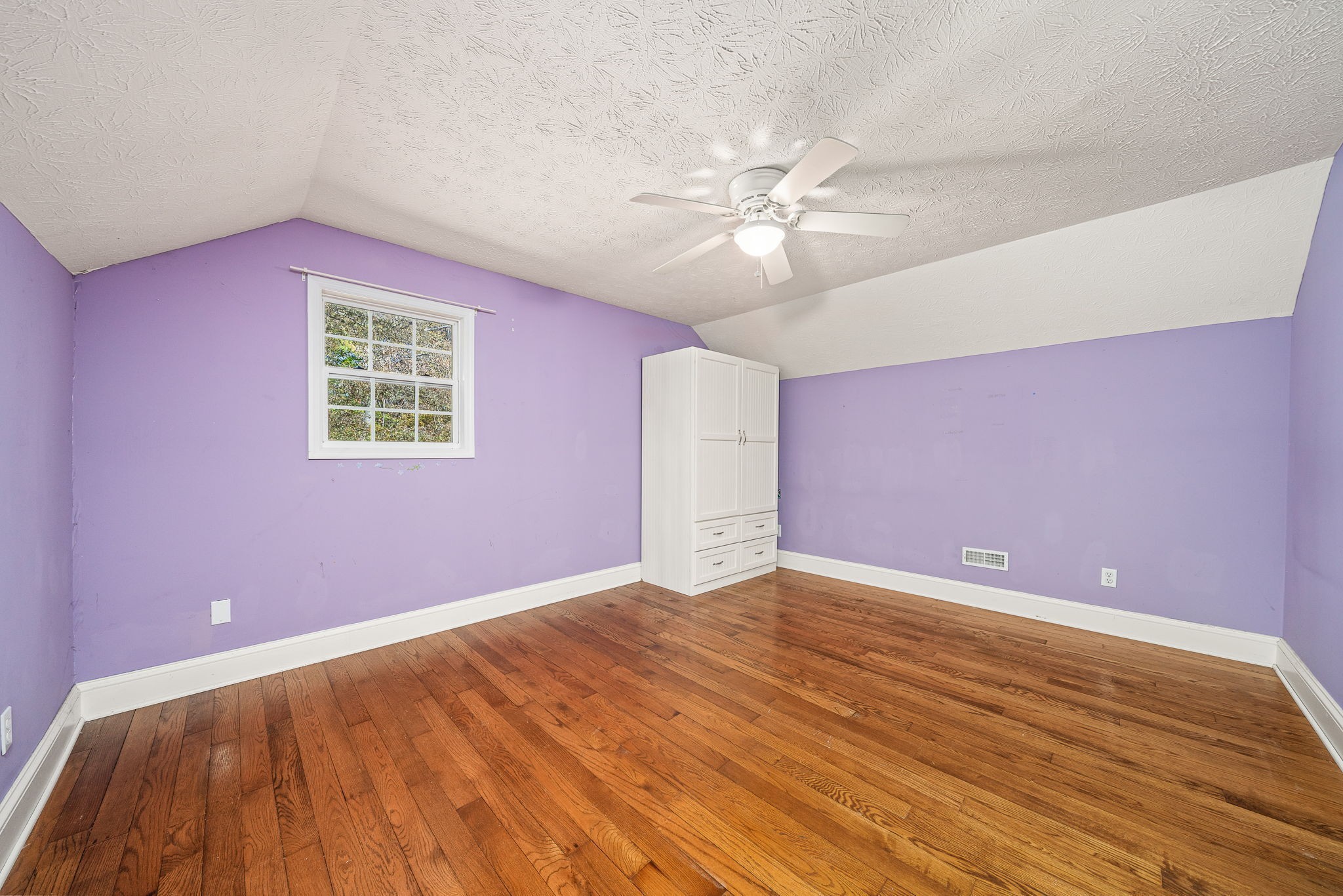 375 Golden Herren Road Sparta, TN 38583 - Photo 43 of 45 a view of an empty room with chandelier fan and wooden floor