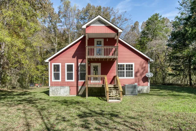 a front view of a house with a yard garage and outdoor seating