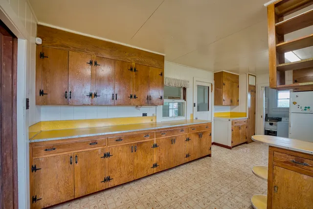 a spacious bathroom with a granite countertop sink mirror and bathtub