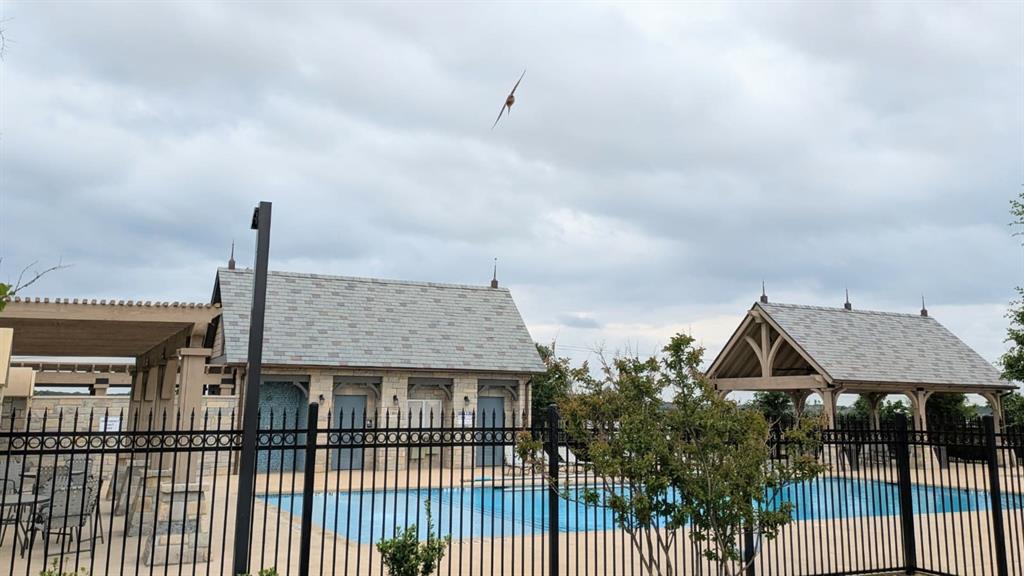 1140 Knightsbridge Road Argyle, TX 76226 - Photo 13 of 13 This amenity area features a swimming pool, two covered structures with pitched roofs, and a black metal fence