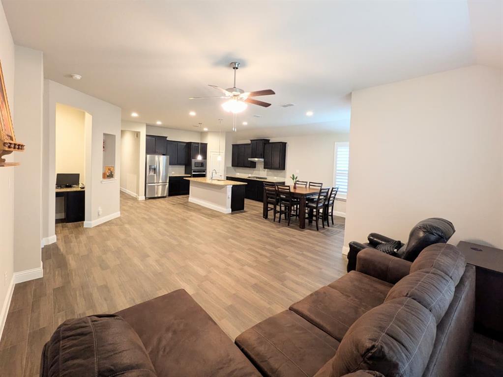 1140 Knightsbridge Road Argyle, TX 76226 - Photo 4 of 13 The property features an open concept living area with wood-look flooring and recessed lighting throughout