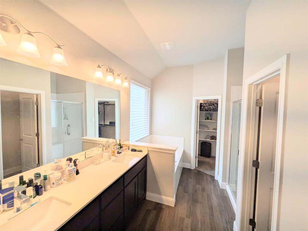 1140 Knightsbridge Road Argyle, TX 76226 - Photo 6 of 13 The bathroom features a double vanity with two sinks, a wall-mounted mirror, and overhead lighting