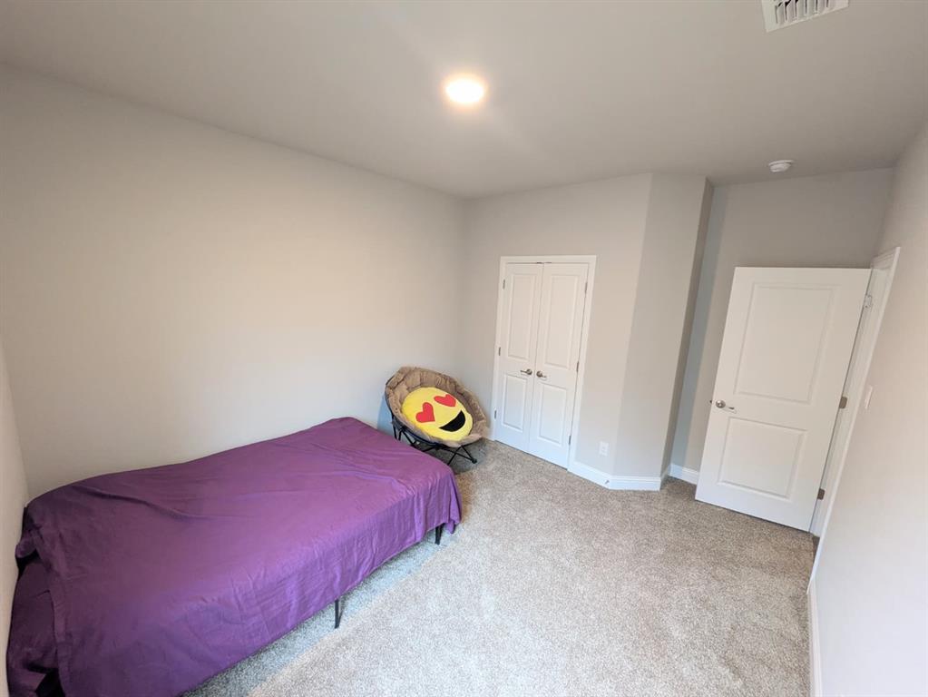 1140 Knightsbridge Road Argyle, TX 76226 - Photo 8 of 13 This room features neutral-toned walls and carpeting, a ceiling light fixture, and a closet with double doors