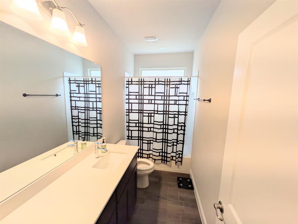 1140 Knightsbridge Road Argyle, TX 76226 - Photo 9 of 13 Bathroom featuring a vanity with an integrated sink, a large mirror, and tiled flooring